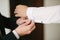 A groom fastening a cuff-link