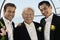 Groom with father and best man outdoors (portrait)