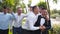 Groom flexing and having fun walking with groomsmen on wedding day. Happy classy man in black suit, bow tie and
