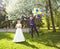 Groom flies on the balloons, but the bride holds his hand. Funny wedding. Groom jumps and flies on balloons. Young