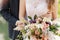 The groom gently embraces the bride behind