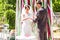 Groom giving an engagement ring to his bride under the arch. Wedding and honeymoon concept.