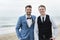 Groom and groomsman at the beach