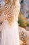 Groom hand lies on the shoulder of bride in a white dress. Close-up