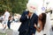 Groom has fun while hiding behind a smiling balloon