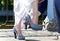 Groom helps bride to put on her shoe