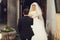 Groom helps charming bride to step out the door