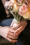 Groom holding in hands delicate, expensive, trendy bridal wedding bouquet of flowers