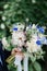 The groom holding a wedding bouquet of peonies