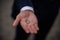 Groom holding wedding rings in hand. Two wedding rings on the floor with contrast wedding rings on floor, on ground, on piano, in