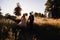 Groom holds bride& x27;s hand while they go down from the hill