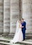 Groom holds bride tender standing on old stone footsteps