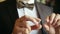 Groom holds golden wedding rings in hands - wedding concept