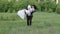 Groom holds his bride in his arms