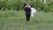 Groom holds his bride in his arms