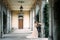 Groom hugs bride leaning against the arch of an old villa. Como, Italy