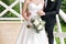 The groom hugs bride. Woman with wedding bouquet. Morning at wedding day at summer. Beautiful mix white peonies and
