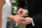 The groom inserting a ring