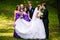 Groom kisses a bride while his friends grimaces behind him