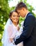 Groom kissing bride summer outdoor.