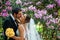 Groom is kissing his beautiful bride in her cheek