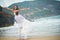 Groom lifted the bride, which spread hand in hand. couple in love on a deserted beach by the sea