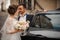 Groom opens the door of the wedding car, intending to kiss the bride