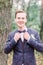 The groom portrait in forest at a wedding day. Young handsome groom in jacket posing on a wedding walk in the forest