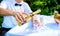 Groom pouring champagne into a glass