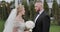 The groom presents a bouquet of flowers to the bride