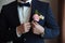 The groom puts on a boutonniere on a wedding day on a jacket