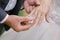 The groom puts on a finger ring wedding bride