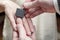 Groom puts a padlock on the finger of the bride as a conception of marriage, demonstrating unfreedom