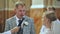 A groom puts a ring on his bride in a Catholic church during a wedding.