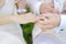 Groom putting a ring on bride\'s finger