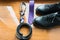 The groom`s and a dogâ€™s wedding accessories. Lilac neck tie and a black leather belt and black shoes on a wooden background.