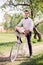 Groom sits on a white bike with a flower basket