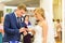 Groom slipping ring on finger of bride at wedding