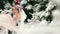 Groom spinning happy bride holding and spinning her in his hands in snow weather fir tree spruce forest during snowfall