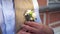 Groom straightens his jacket buttonhole.