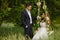 Groom swings the bride on a swing in outdoor park