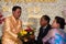 Groom thanks to bride parents kneeling in front of them