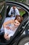 Groom trying to drag the bride out of the car