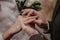 Groom wears golden wedding ring on the bride finger