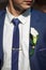 Groom in a wedding jacket and flower