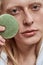 Groomed young blond caucasian man holding wash sponge