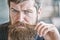 Grooming and barber shop concept. Masculinity and brutality. Male beauty. Macho brutal bearded hipster flirting close up