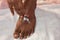 Grooming, body care and people concept - happy african american man applying moisturizer to his hand over white background