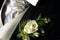 Grooms rose\'s boutonniere,silver tie and black suite