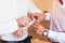 Groomsman helps groom to put on cufflinks close-up